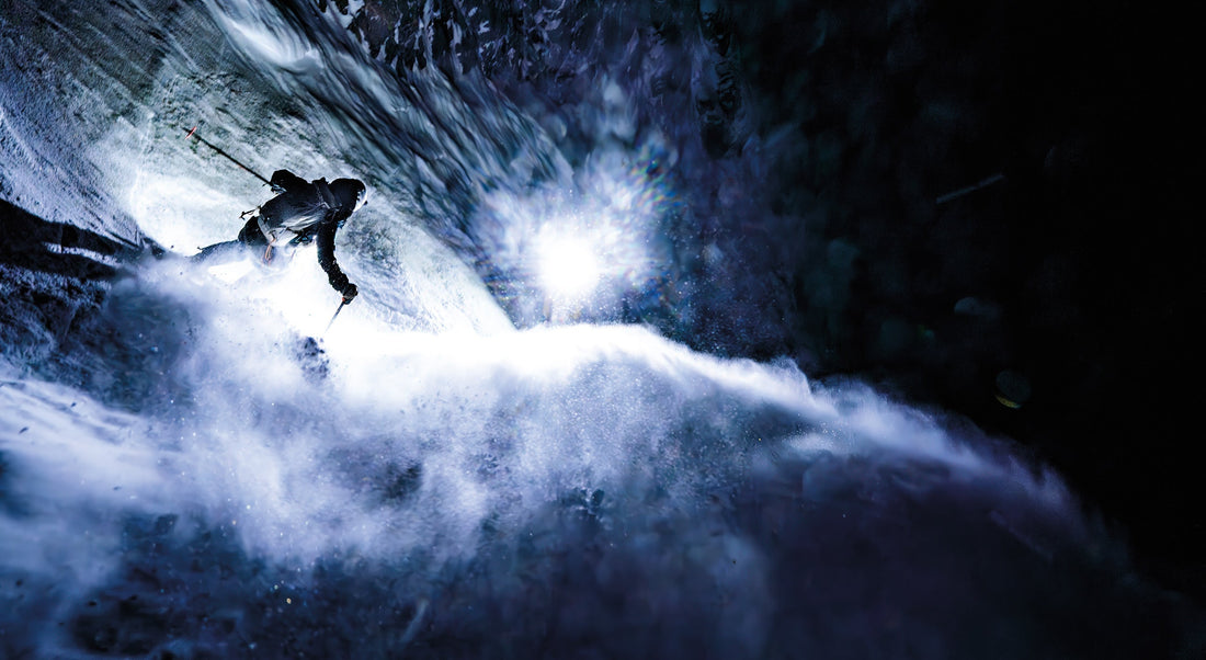 Madison Rose Ostergren forgoes the second rappel and charges over the cave in the Apocalypse Couloir in the Teton Range, while Jim Ryan, Erich Roepke, and Clayton Hermann light up the rock walls with their headlamps. Photo: Clayton Herrmann