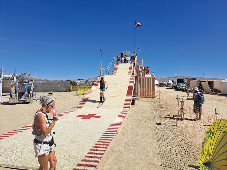 Yes, you can ski at Burning Man. Burners test the dry ski slope at Lake Lahontan Ski Resort, the first and only artificial ski slope in Black Rock City. Photo: Jamey Mossengren