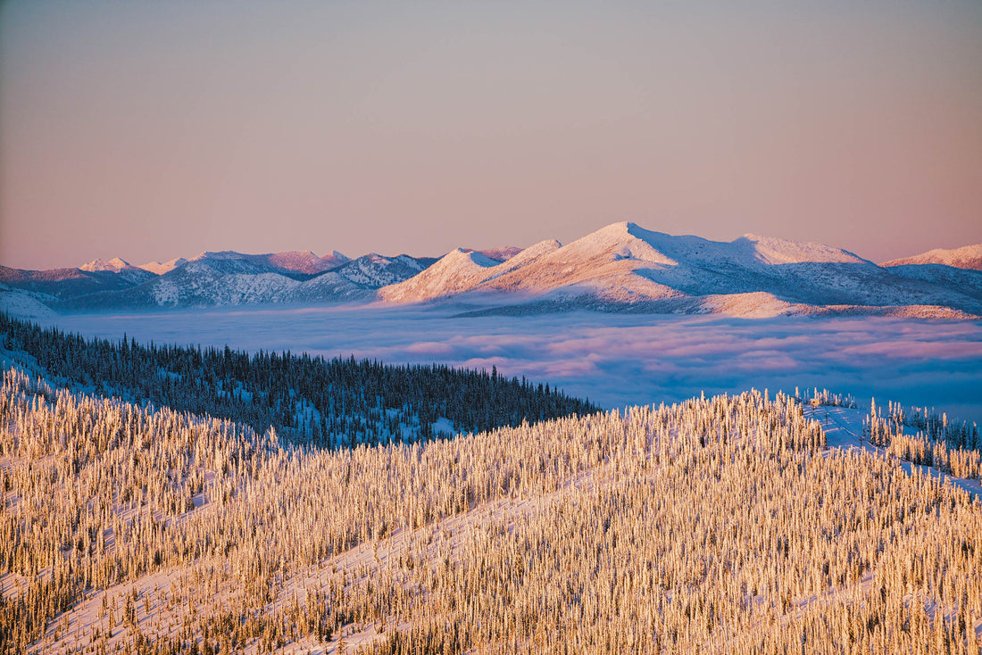“Schweitzer Mountain and BC’s Selkirk Range at sunset, draped in a sea of clouds and a golden glow. Photo: Jasper Gibson